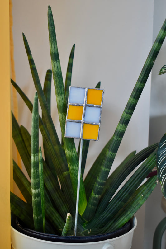 Potted plant with a decorative glass panel in front